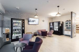 a store with chairs and tables and a brick wall at Hotel Smart Liv'in in Böheimkirchen