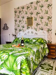a bedroom with a bed with a bottle of wine on it at Francesca House in Atrani +40 photos