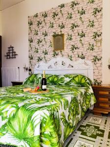 a bedroom with a bed with a bottle of wine on it at Francesca House in Atrani