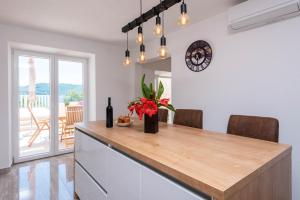 a kitchen with a counter with a vase of flowers at Holiday Villa Sasha in Kučište