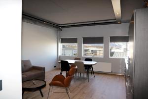 a living room with a table and chairs at Tryggvabraut 24 One Bedroom Apartment in Akureyri