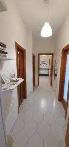 a room with a hallway with a white tile floor at Il Balconcino in Naples