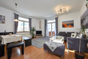 a living room with a couch and a table at Apartments Alte Villa in Garmisch-Partenkirchen