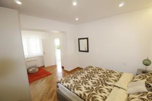 a bedroom with a bed with a animal print blanket at Holiday house PUNTA Umag II in Umag