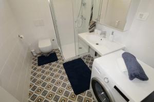 a bathroom with a washing machine and a sink at Holiday house PUNTA Umag II in Umag +18 photos