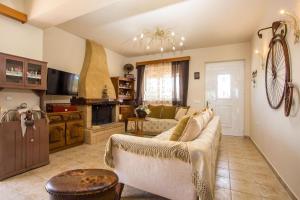 a living room with a couch and a table at Laylande House in Theologos