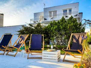 a group of chairs sitting on a patio at Malmaris in Władysławowo