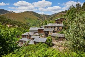 a group of buildings on a hill with trees at Cottage da Paradinha: Passadiços do Paiva - Arouca in Paradinha