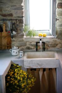 a sink in a kitchen next to a window at Onos Eco Living in Mési