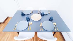 a table with plates and utensils on it at 1A BEACH & BUSINESS Apartment in the City CENTER! in Larnaka