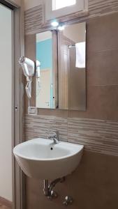 a bathroom with a white sink and a mirror at La Fenice Salentina in Alezio +64 photos