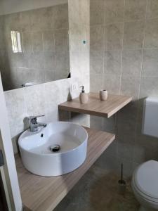 a bathroom with a white sink and a toilet at Gi&Sa in Gallipoli