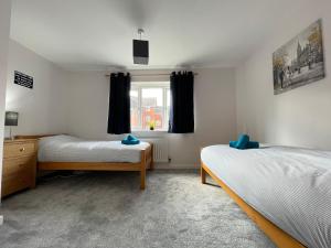 a bedroom with two beds and a window at Grand Central House, Pride Park in Derby