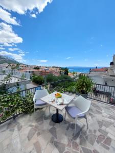 a balcony with a table and chairs and the ocean at Apartments Matić in Baška Voda