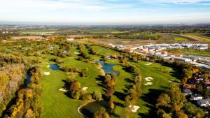 an aerial view of a golf course with a river at Holiday Inn Express Munich - Olching, an IHG Hotel in Olching