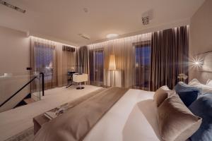 a large bedroom with a large bed and large windows at ONE Luxury Apartments in Rzeszów