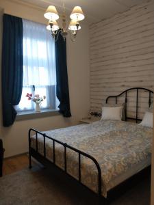 A bed or beds in a room at Klára-Háza Vendégház