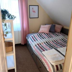 A bed or beds in a room at Klára-Háza Vendégház