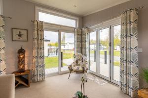 a living room with a large sliding glass door at Inside No 1 Retreat Carnforth in Carnforth