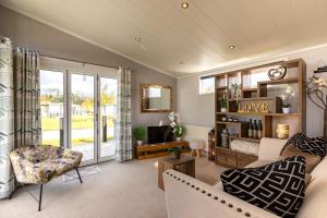 a living room with a couch and a tv at Inside No 1 Retreat Carnforth in Carnforth