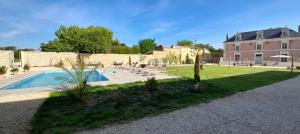 een huis met een zwembad in een tuin bij La Galuche in Angliers