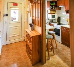 a kitchen with a counter and a table and chairs at Dia Apartman in Miskolc