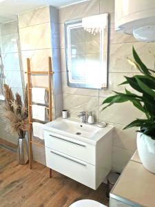 a bathroom with a white sink and a mirror at Elegance Suite Martina in Orebić