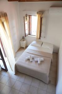 a bedroom with two beds with towels on them at Agapi Holiday Home in Rethymno