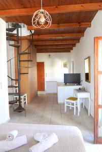 a room with a bed and a desk and a ladder at Agapi Holiday Home in Rethymno