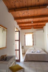 a bedroom with a bed and a wooden ceiling at Agapi Holiday Home in Rethymno