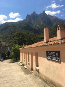 a sign on the side of a building with mountains in the background at Mare Nostrum in Porto Ota