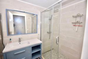 a bathroom with a sink and a shower at La Gaviota apartment, in the heart of the port in Jávea