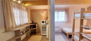 a small room with a bunk bed and a microwave at Namiņš pie jūras. in Saulkrasti