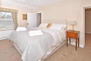 a bedroom with a bed with a teddy bear on it at The Fountain Inn in Leek