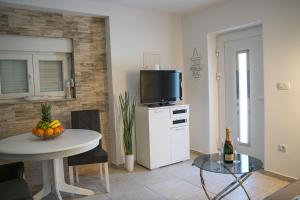a living room with a table and a tv on top at Holiday Home Relax - Mošćenička Draga in Mošćenička Draga