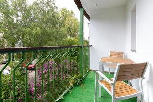 a balcony with a table and chairs and flowers at Apartament Zielony Sopot Karlikowo by Renters in Sopot