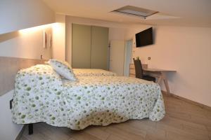 ein Schlafzimmer mit einem Bett mit einer weißen Decke in der Unterkunft B&B Canavaccio in Urbino