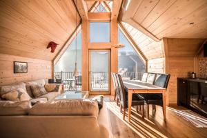 a living room with a couch and a table at Domki Karpielówka Luxury Chalet in Kościelisko