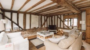 a living room with two couches and a tv at Partridge Lodge Self Catering houses in Woodbridge