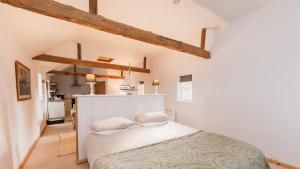 a bedroom with a white bed with two pillows at Partridge Lodge Self Catering houses in Woodbridge