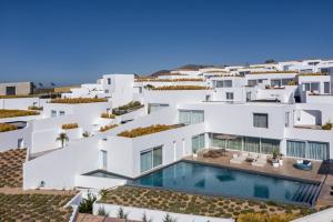 an aerial view of a white building with a swimming pool at Andronis Arcadia Hotel in Oia