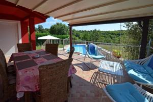 a patio with a table and chairs and a pool at Villa Ketty in Kanfanar