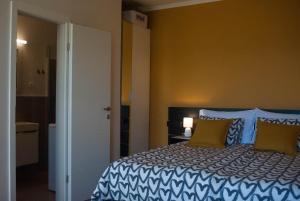 a bedroom with a bed with blue and yellow walls at Kiwi Studio in Opatija