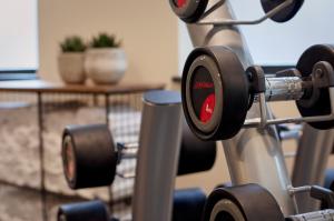 a gym with two dumbbells on a machine at Citadines Barbican London in London