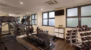 a gym with two treadmills and two machines at Citadines Barbican London in London
