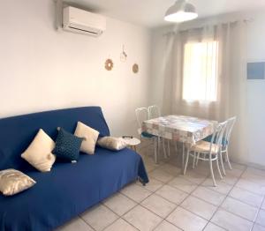 a living room with a blue couch and a table at Mare Nostrum in Porto Ota