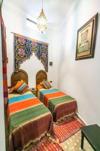 Postel nebo postele na pokoji v ubytování Riad Jardin Chrifa
