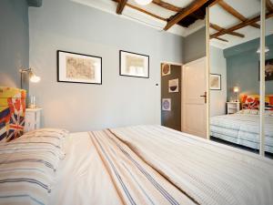 a bedroom with a large bed and a bedroom with a bed sqor at DIMORA DEL CARMINE ACQUARIO - GENOVABNB it in Genova