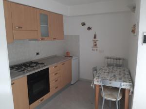 een kleine keuken met een fornuis en een tafel bij Appartamento Il giardino in Levanto +3 foto's