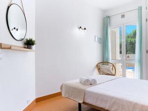 a white bedroom with a bed and a mirror at REFÚGIO DO CARANGUEJO - Praia da Luz - WiFi, Private Pool & BBQ in Luz +41 photos